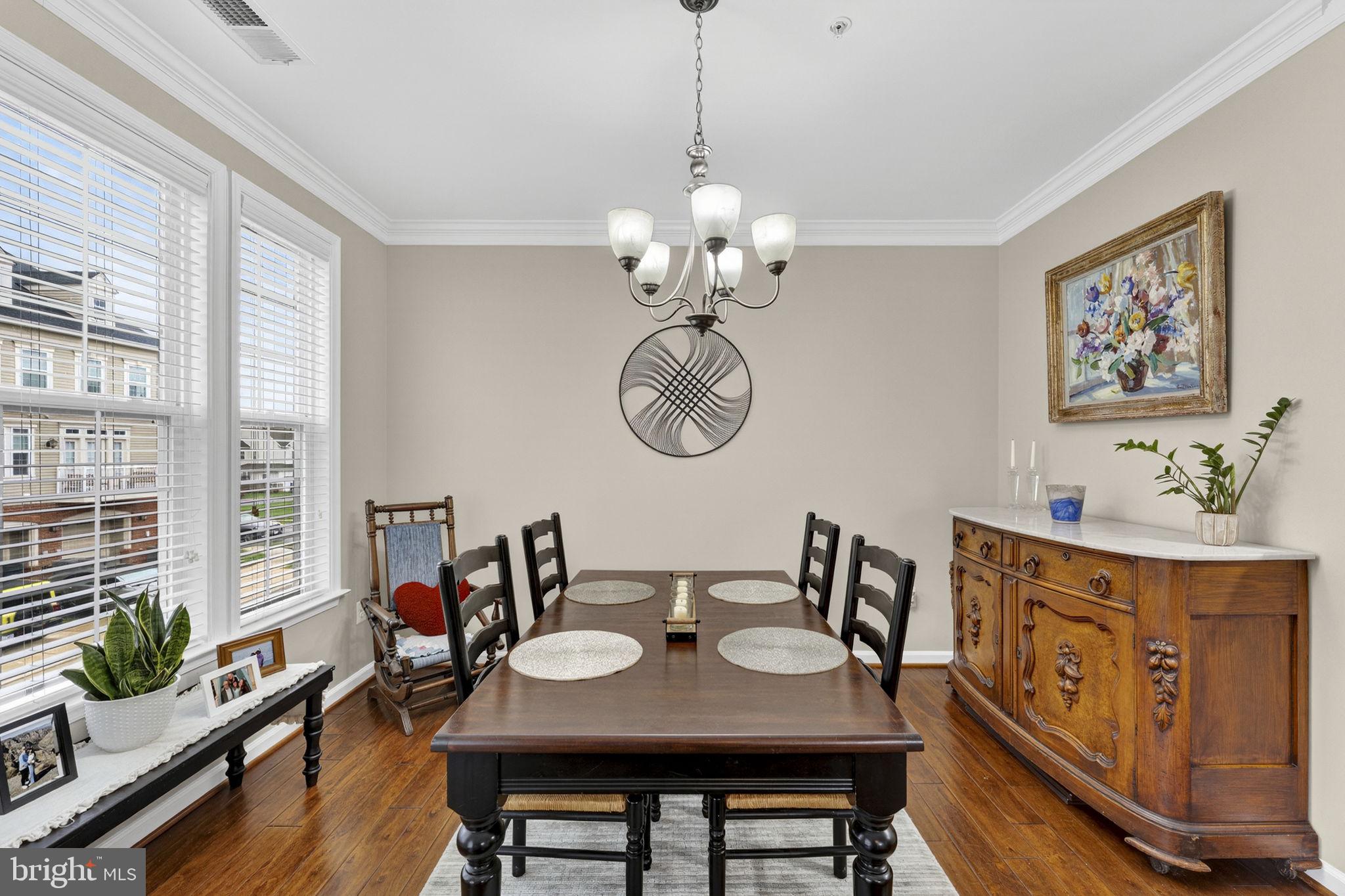 42558 Sunset Ridge Square Ashburn, VA 20148 - Photo 22 of 51 a view of a dining room with furniture a chandelier and wooden floor