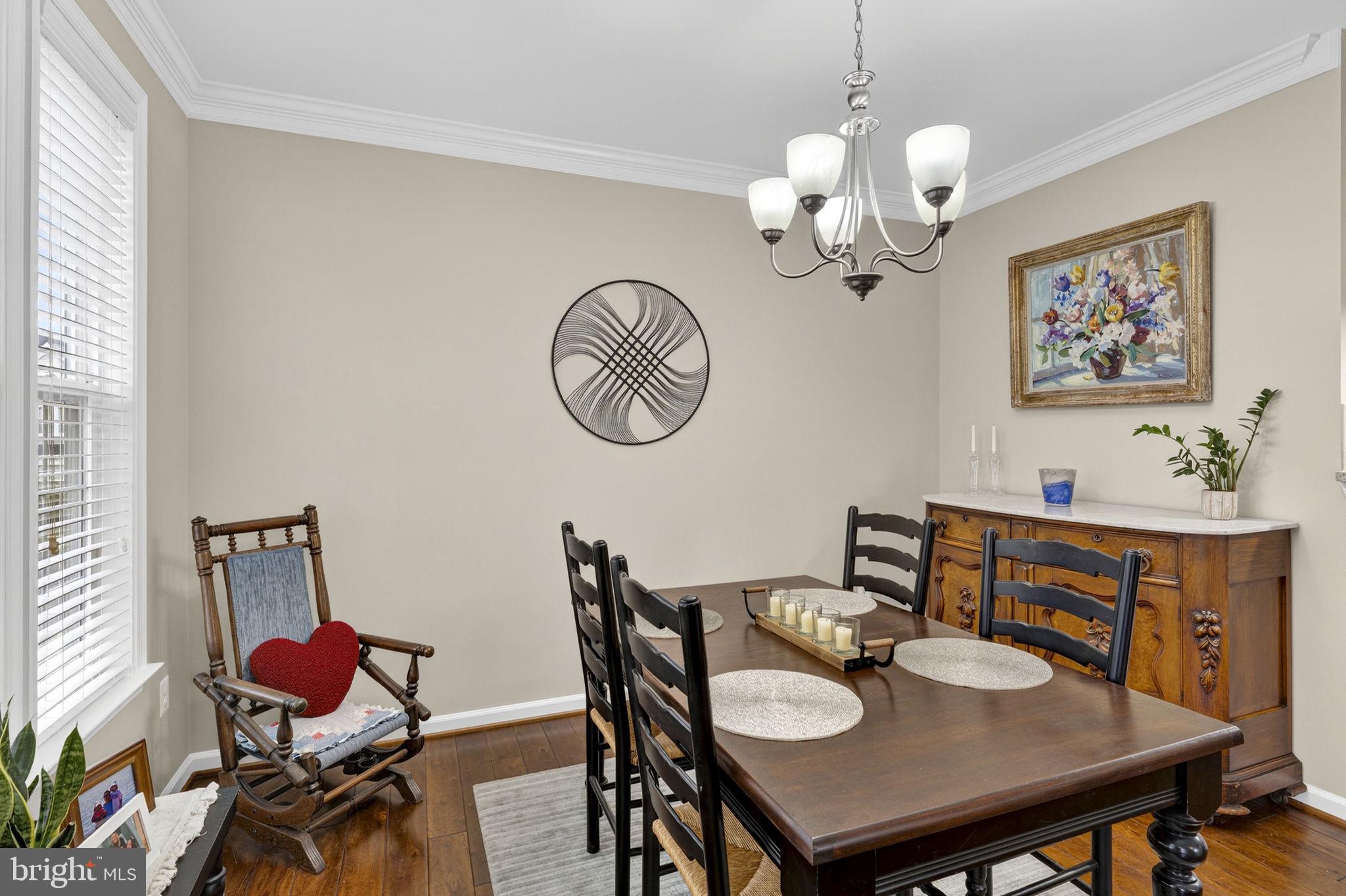 42558 Sunset Ridge Square Ashburn, VA 20148 - Photo 25 of 51 a view of a dining room with furniture wooden floor and a chandelier