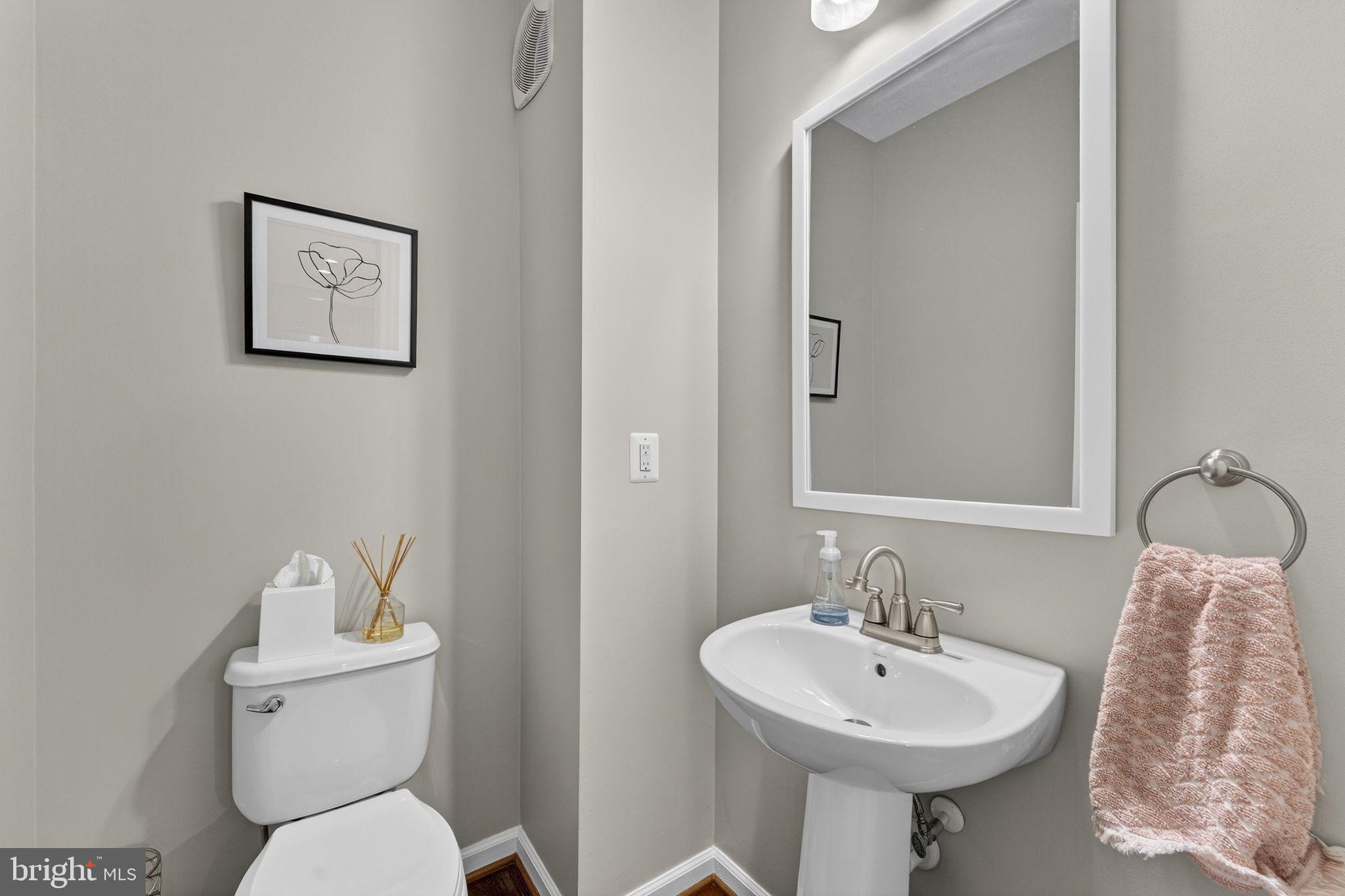 42558 Sunset Ridge Square Ashburn, VA 20148 - Photo 30 of 51 a bathroom with a toilet sink and mirror