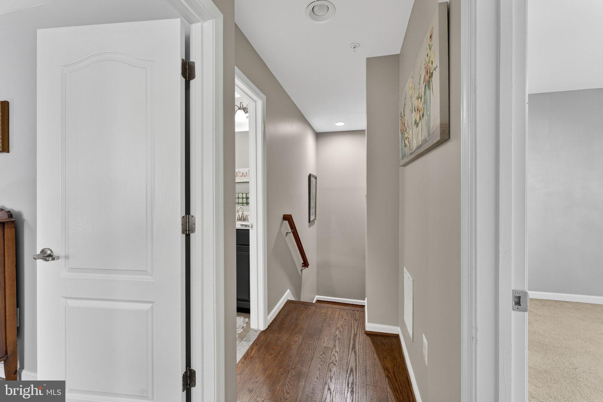 42558 Sunset Ridge Square Ashburn, VA 20148 - Photo 33 of 51 a view of a hallway with wooden floor and staircase