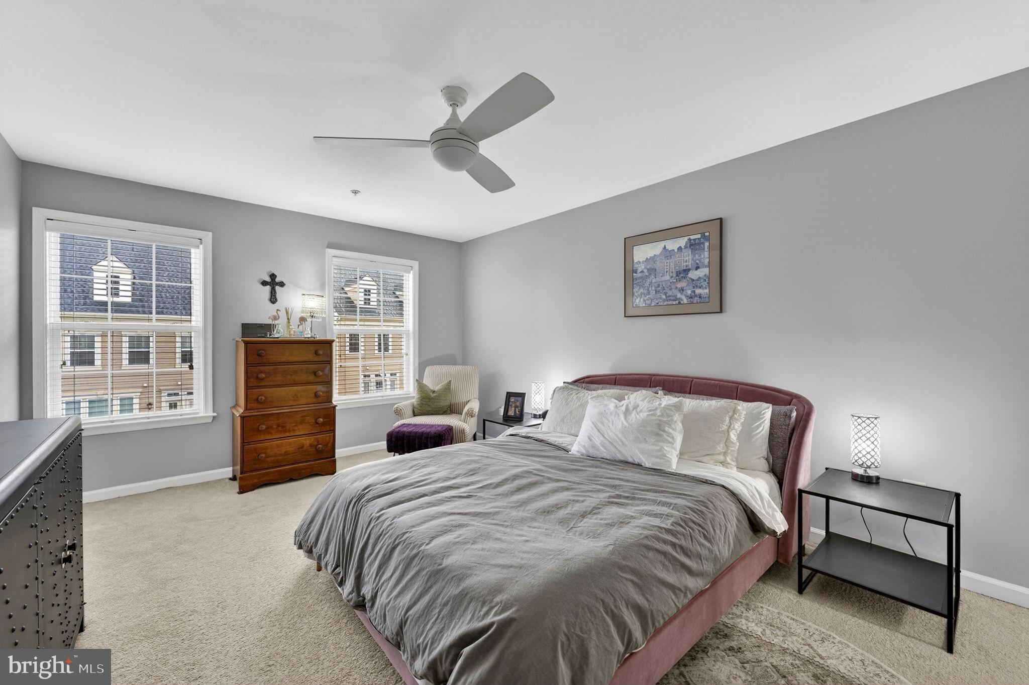 42558 Sunset Ridge Square Ashburn, VA 20148 - Photo 34 of 51 a bedroom with a bed and dresser with wooden floor