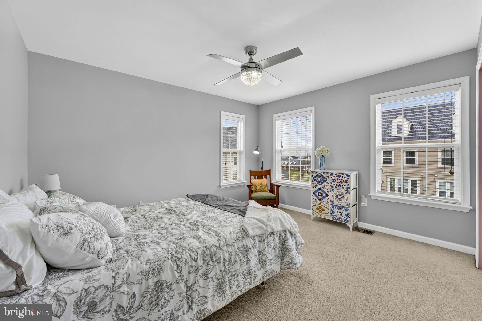 42558 Sunset Ridge Square Ashburn, VA 20148 - Photo 42 of 51 a bedroom with a bed and ceiling fan