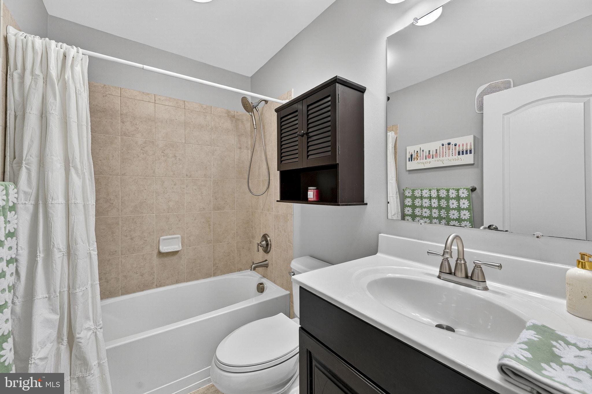 42558 Sunset Ridge Square Ashburn, VA 20148 - Photo 46 of 51 a bathroom with a sink toilet a mirror and shower