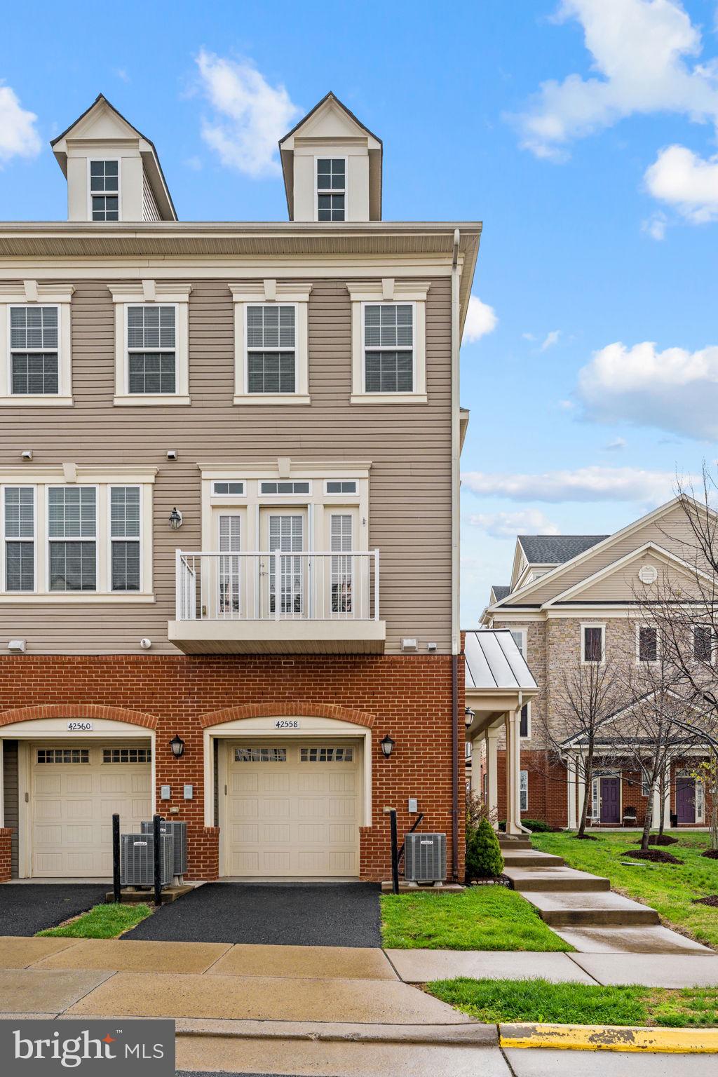 42558 Sunset Ridge Square Ashburn, VA 20148 - Photo 5 of 51 a front view of a building with a garden