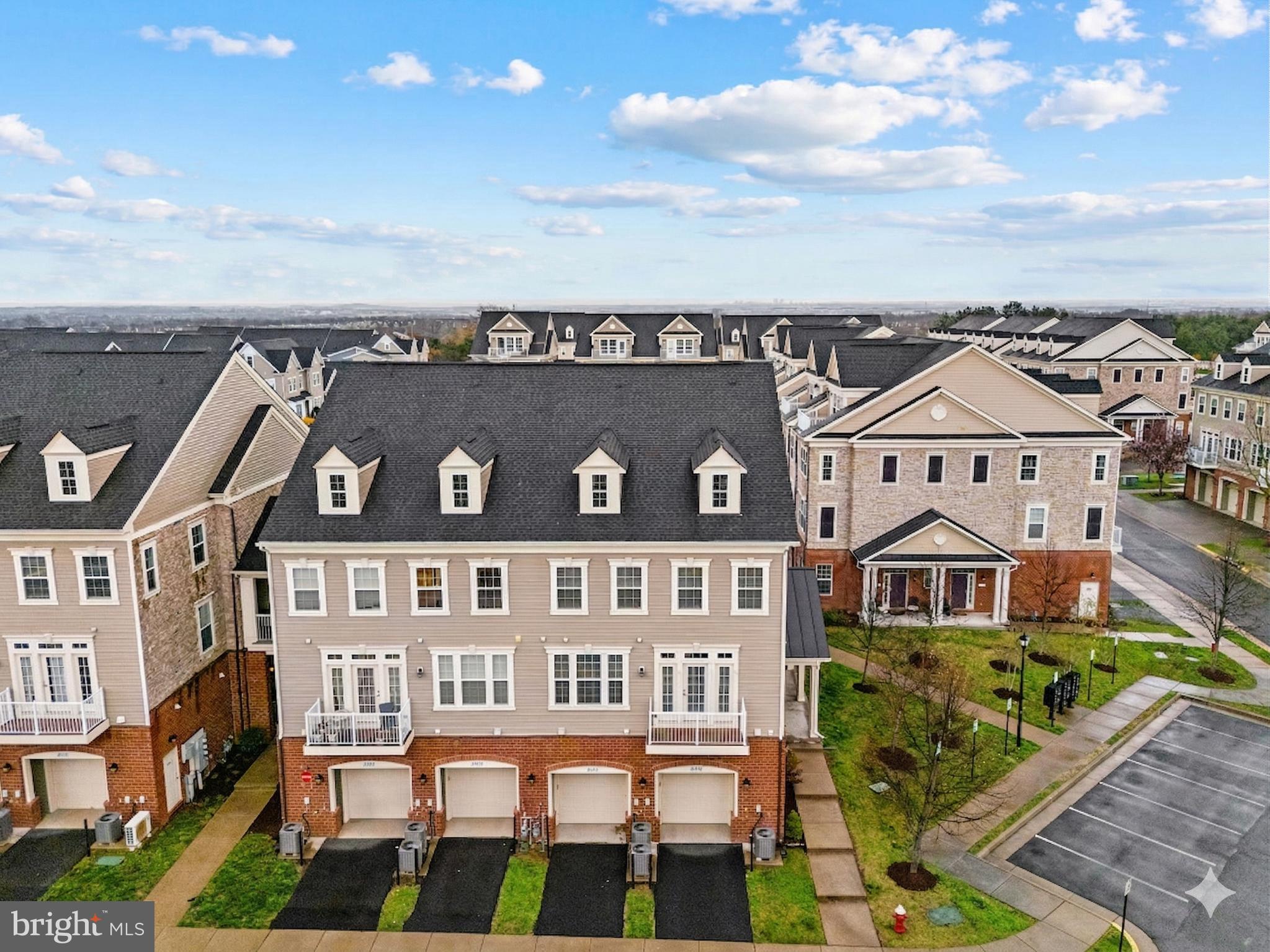 42558 Sunset Ridge Square Ashburn, VA 20148 - Photo 51 of 51 a front view of a residential apartment building with a yard