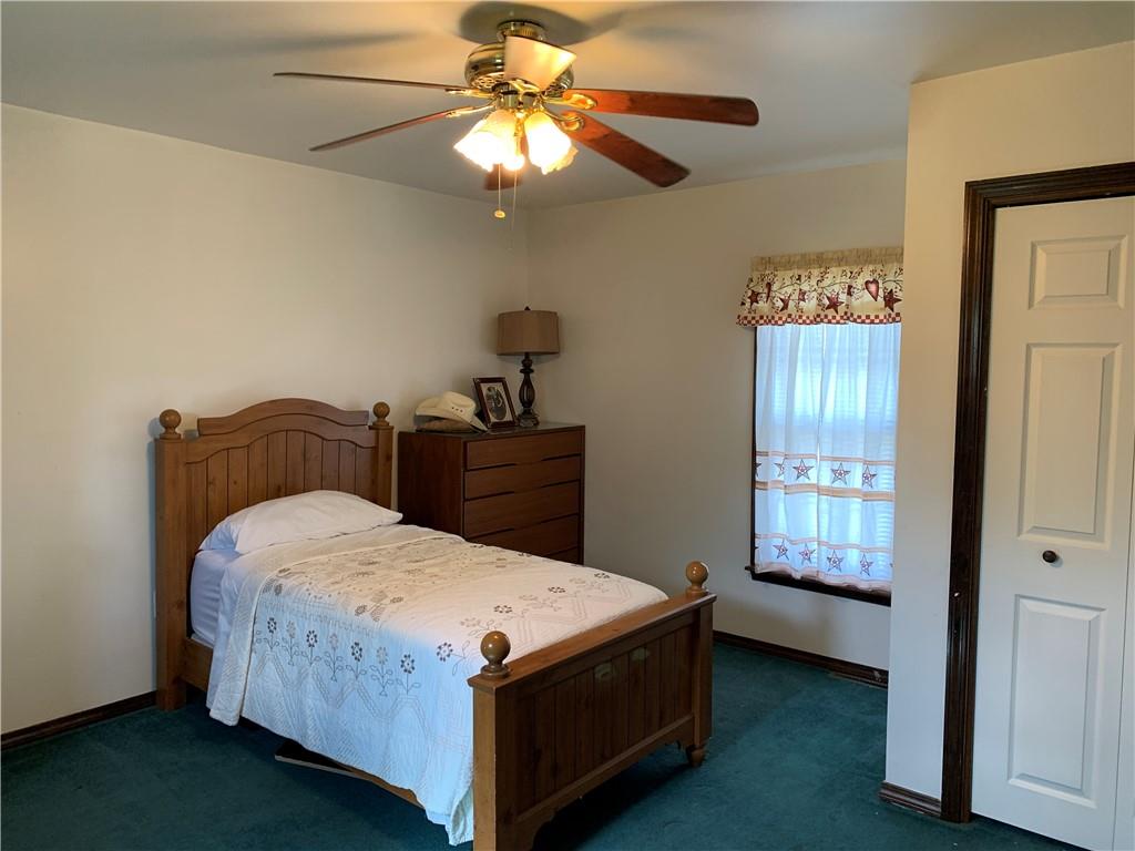 729 Cemetery Road Perryopolis, PA 15473 - Photo 21 of 24 a bedroom with a bed and a chandelier