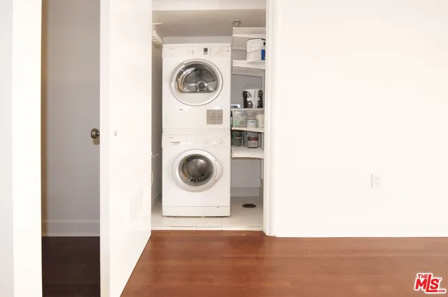 a view of a storage & utility room with dryer and washer