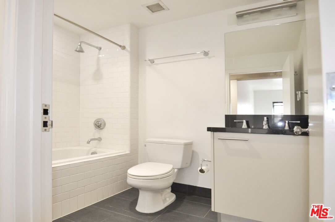 416 South Spring Street, Unit 805 Los Angeles, CA 90013 - Photo 17 of 24 a bathroom with a sink a toilet and shower