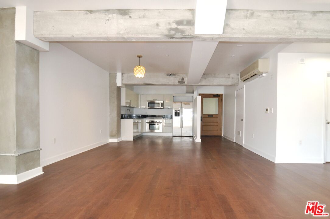 416 South Spring Street, Unit 805 Los Angeles, CA 90013 - Photo 5 of 24 a view of empty room with wooden floor