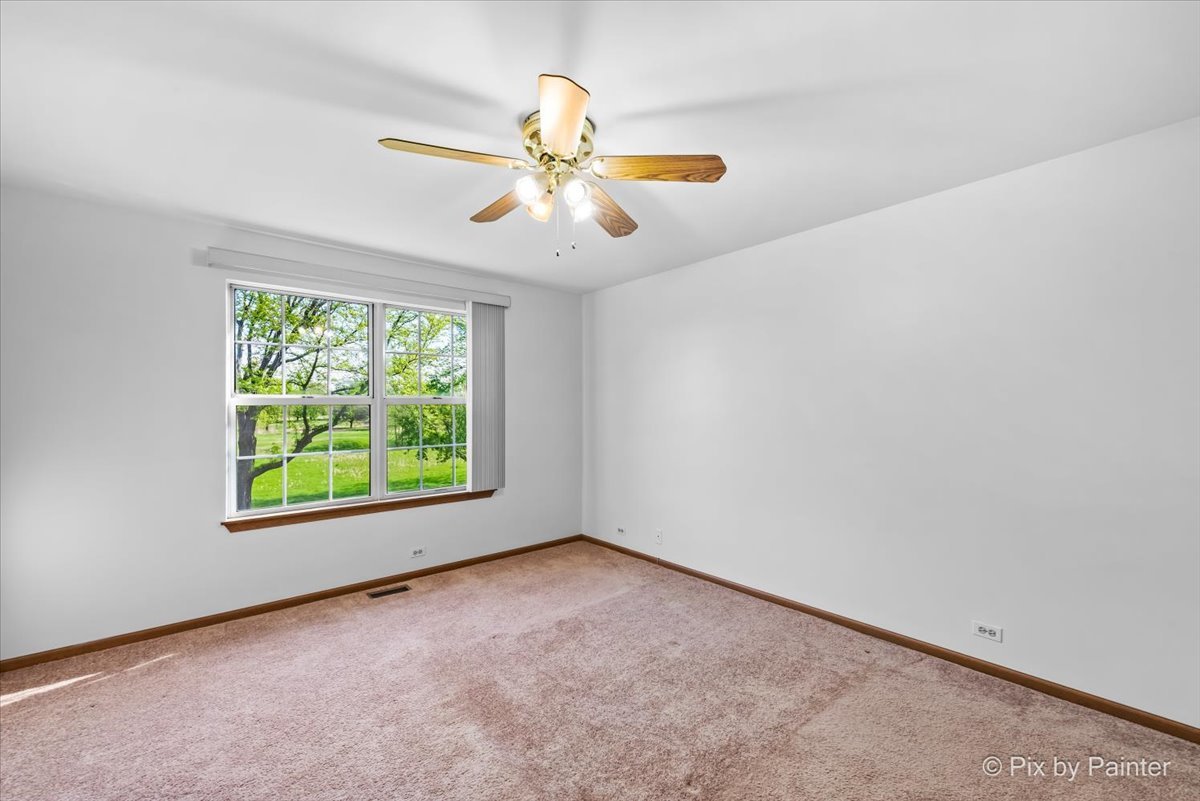 1664 Pebble Beach Circle Elgin, IL 60123 - Photo 17 of 24 an empty room with windows and fan