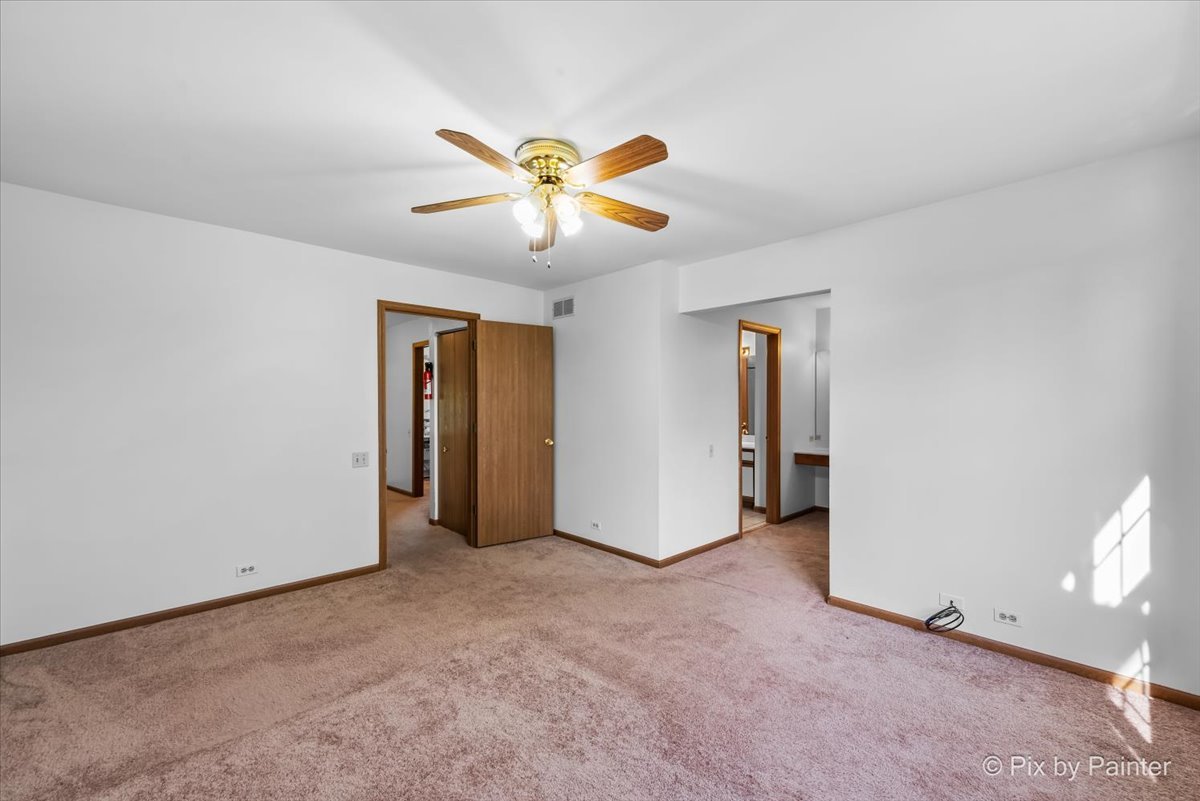 1664 Pebble Beach Circle Elgin, IL 60123 - Photo 18 of 24 a view of a livingroom with a ceiling fan and window