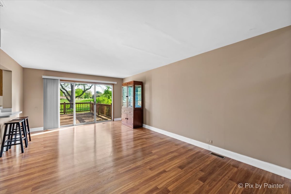 1664 Pebble Beach Circle Elgin, IL 60123 - Photo 4 of 24 a view of an empty room with wooden floor and a window