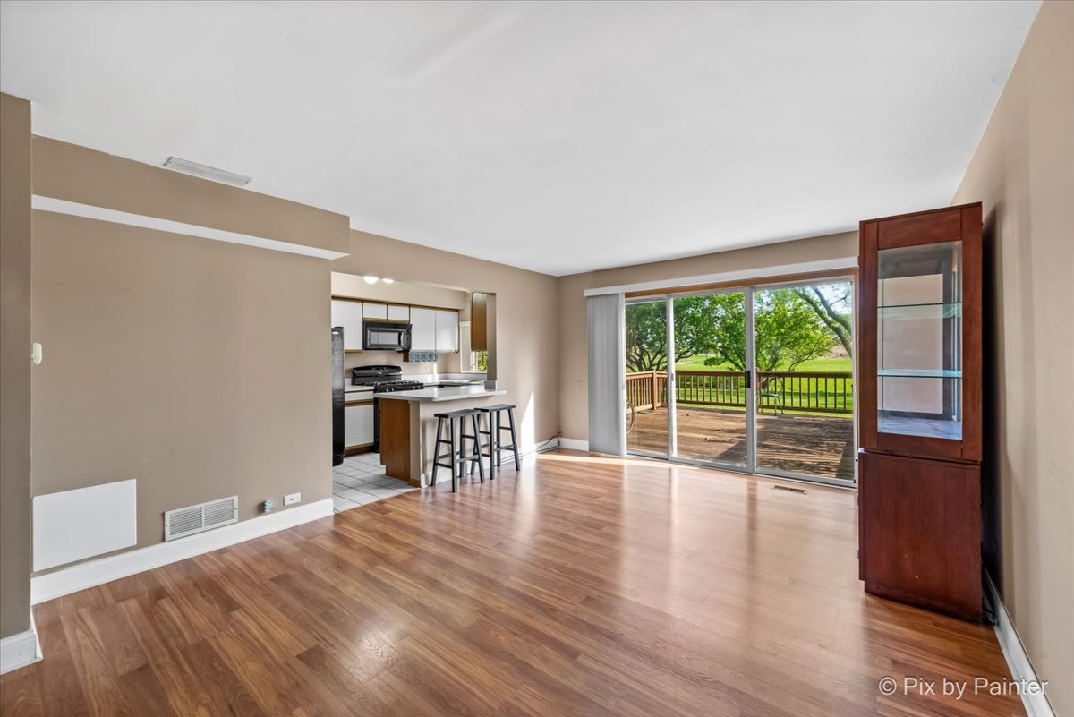 1664 Pebble Beach Circle Elgin, IL 60123 - Photo 5 of 24 a view of a kitchen with wooden floor and electronic appliances