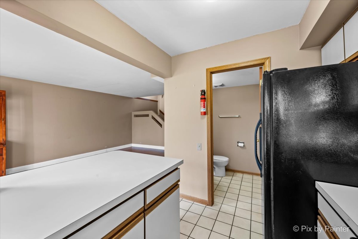 1664 Pebble Beach Circle Elgin, IL 60123 - Photo 9 of 24 a kitchen with a refrigerator and a sink