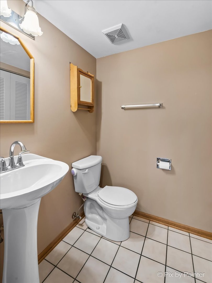 1664 Pebble Beach Circle Elgin, IL 60123 - Photo 10 of 24 a bathroom with a sink toilet and mirror