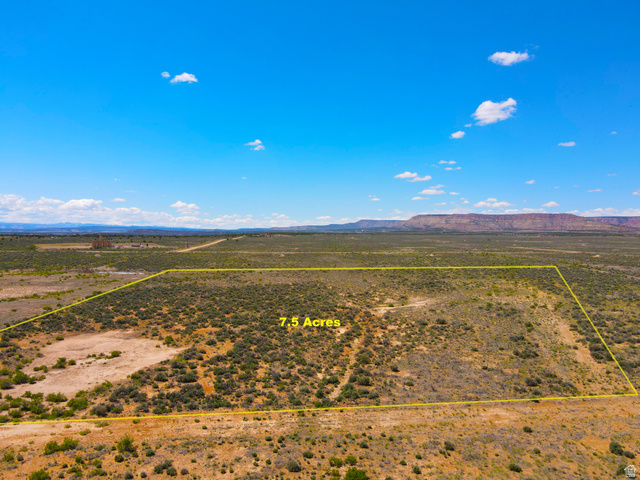 4500 South 22750th Duchesne, UT 84021 - Photo 6 of 34 Expansive 7.5-acre parcel featuring natural desert vegetation, defined property lines, and distant mountain ranges under a clear sky