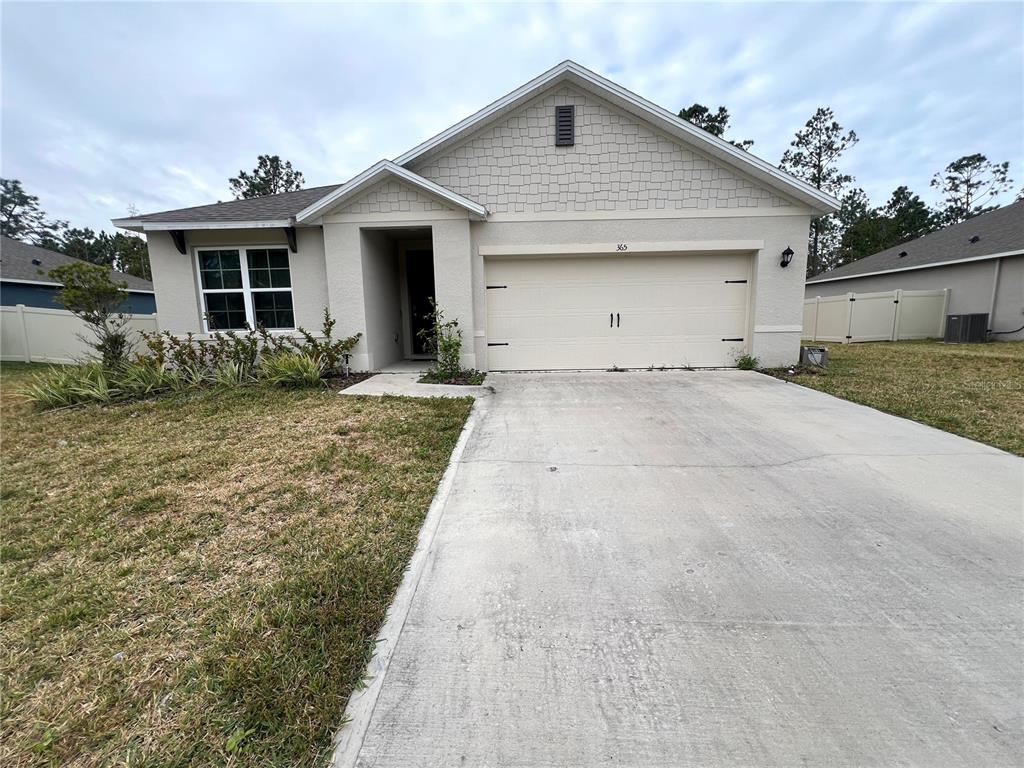 365 Sunset Point Drive Ormond Beach, FL 32174 - Photo 1 of 1 a front view of a house with garden