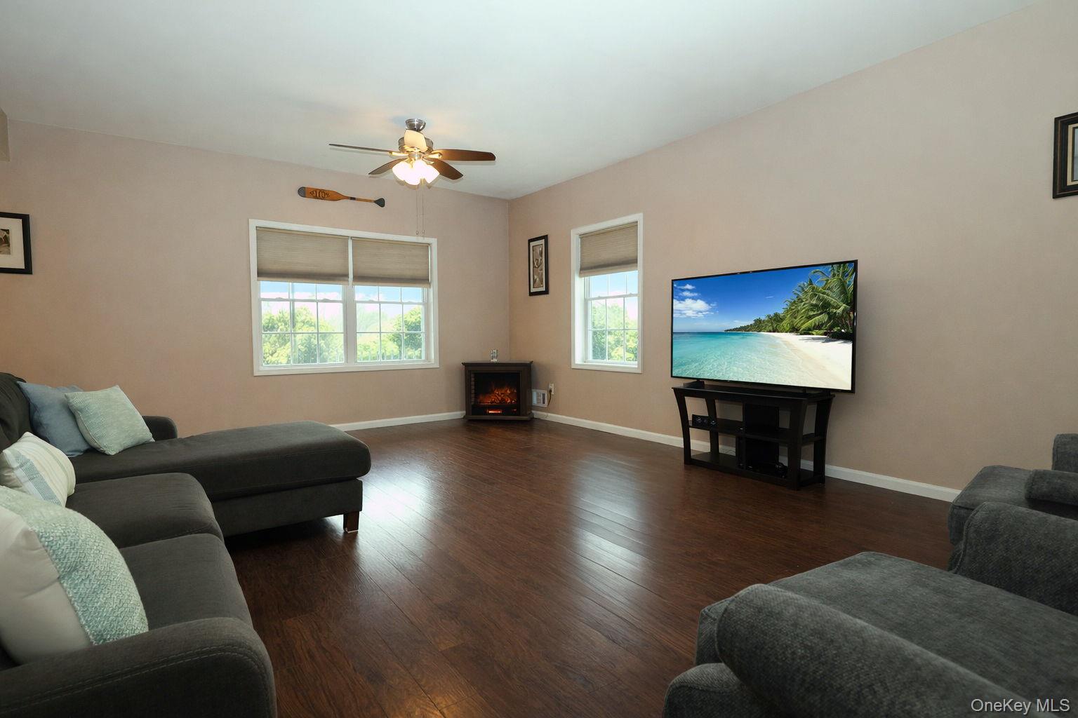 1 Decker Farm Road Monticello, NY 12701 - Photo 3 of 12 a living room with furniture and a flat screen tv with wooden floor
