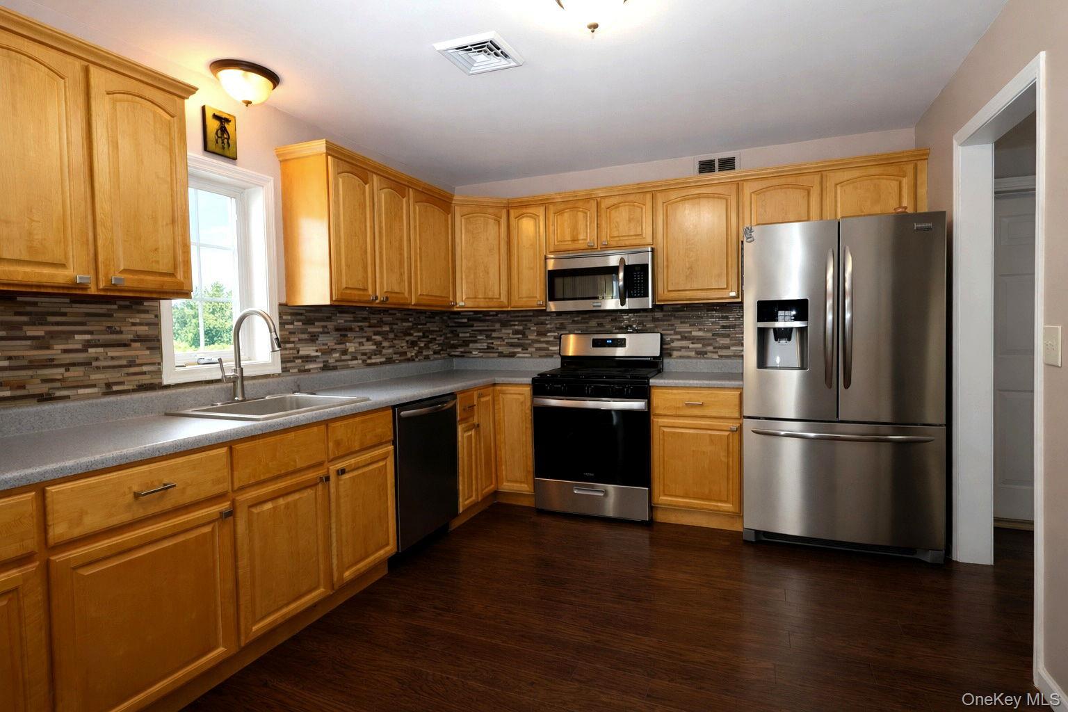 1 Decker Farm Road Monticello, NY 12701 - Photo 5 of 12 a kitchen with stainless steel appliances a refrigerator stove microwave and sink