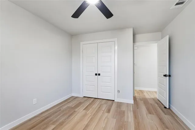 a view of an empty room and wooden floor
