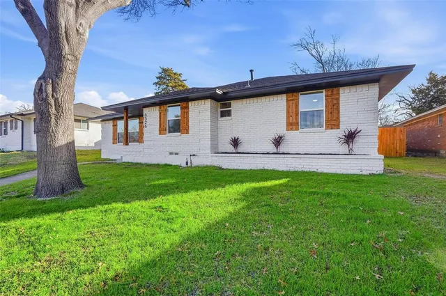 a front view of house with yard and outdoor seating