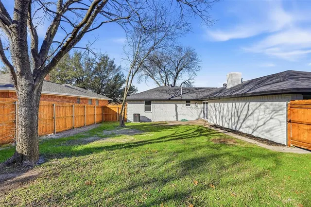 a view of a backyard with large trees