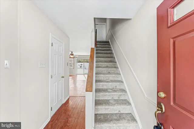 a view of a hallway with wooden floor and entryway