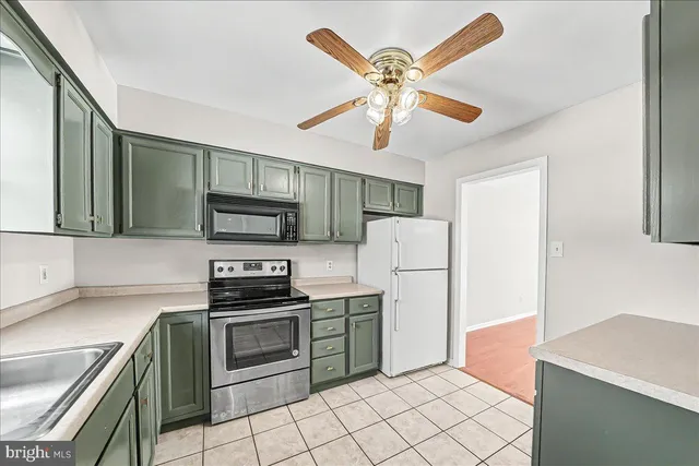 a kitchen with stainless steel appliances a refrigerator and a stove top oven