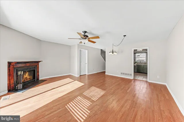 a view of an empty room and wooden floor