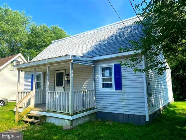 a view of a house with a yard and wooden fence