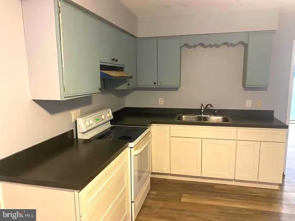 a kitchen with a sink and a stove top oven