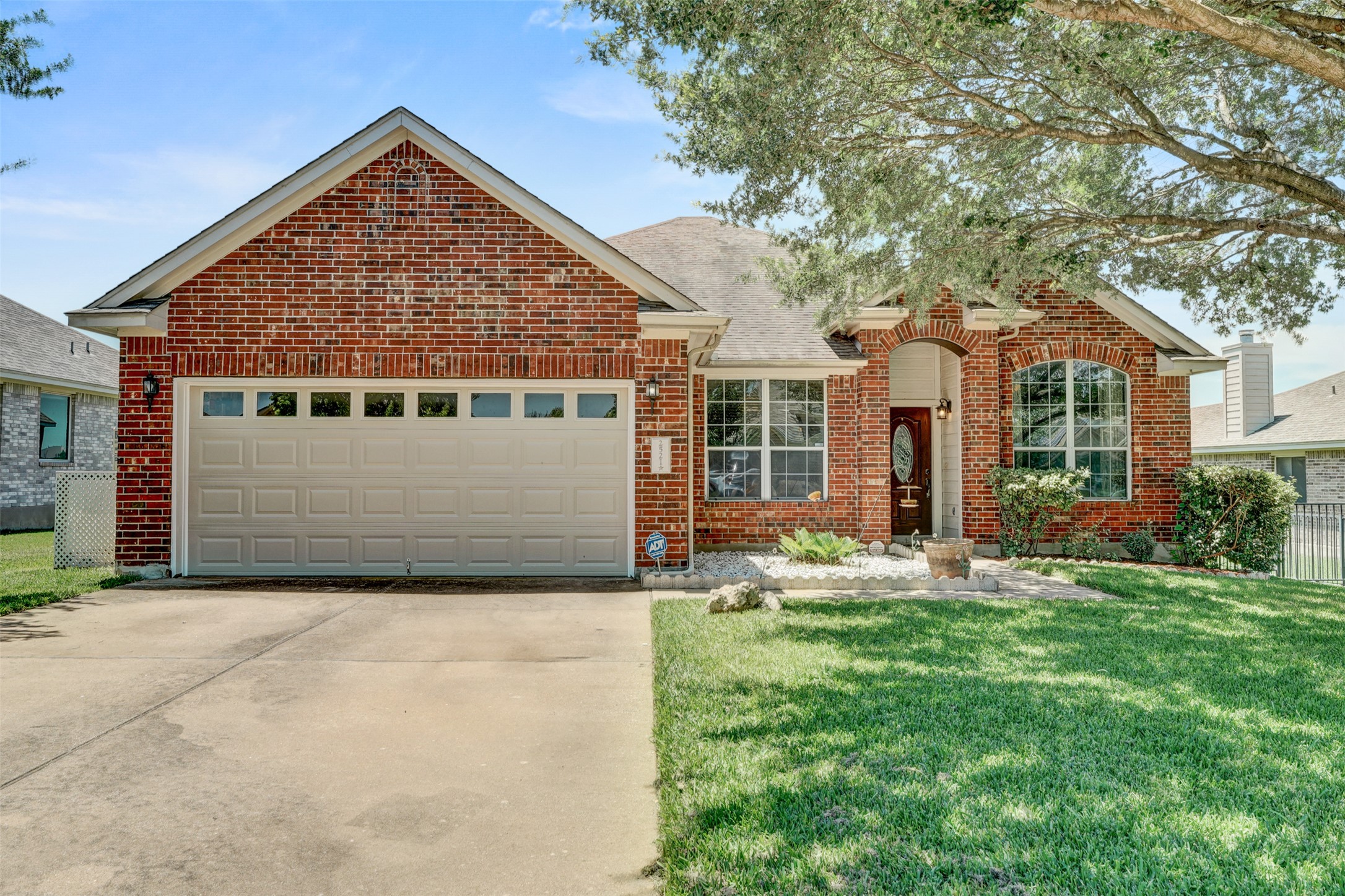 2521 Amen Corner Road Pflugerville, TX 78660 - Photo 4 of 40 Brick facade residence featuring an attached two-car garage with transom windows