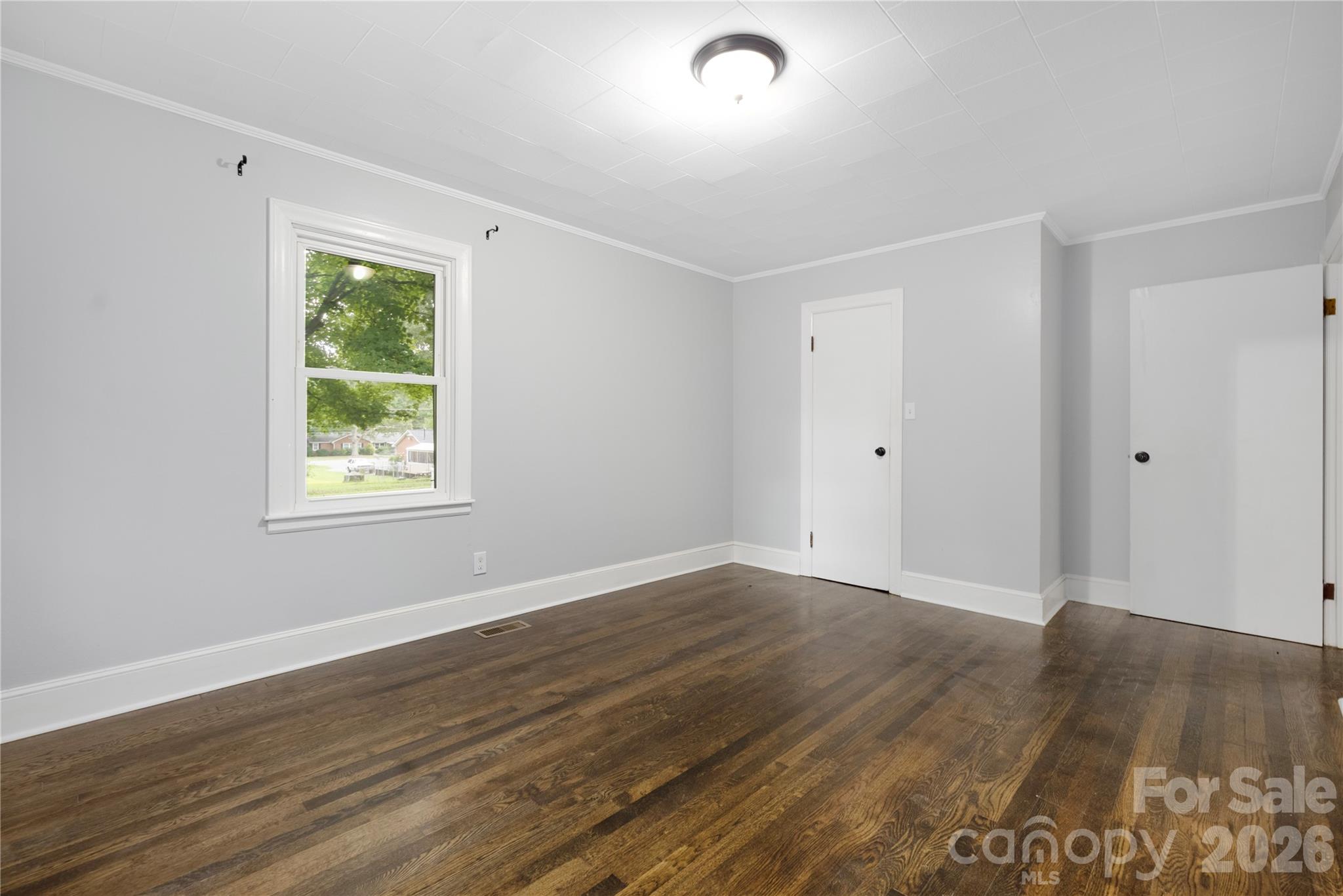 146 Staton Road Gastonia, NC 28056 - Photo 15 of 25 an empty room with wooden floor and windows