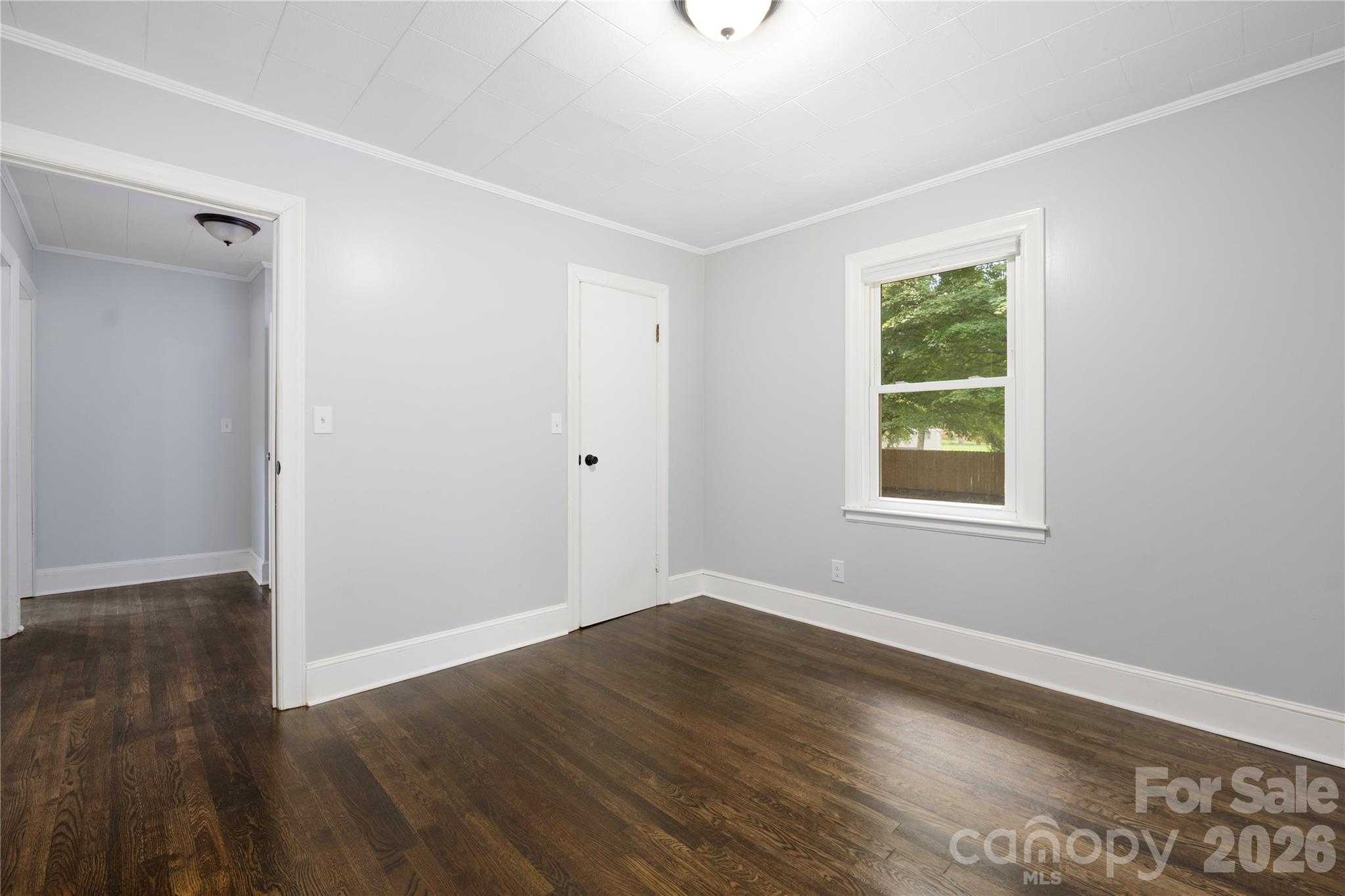 146 Staton Road Gastonia, NC 28056 - Photo 17 of 25 a view of an empty room with wooden floor and a window