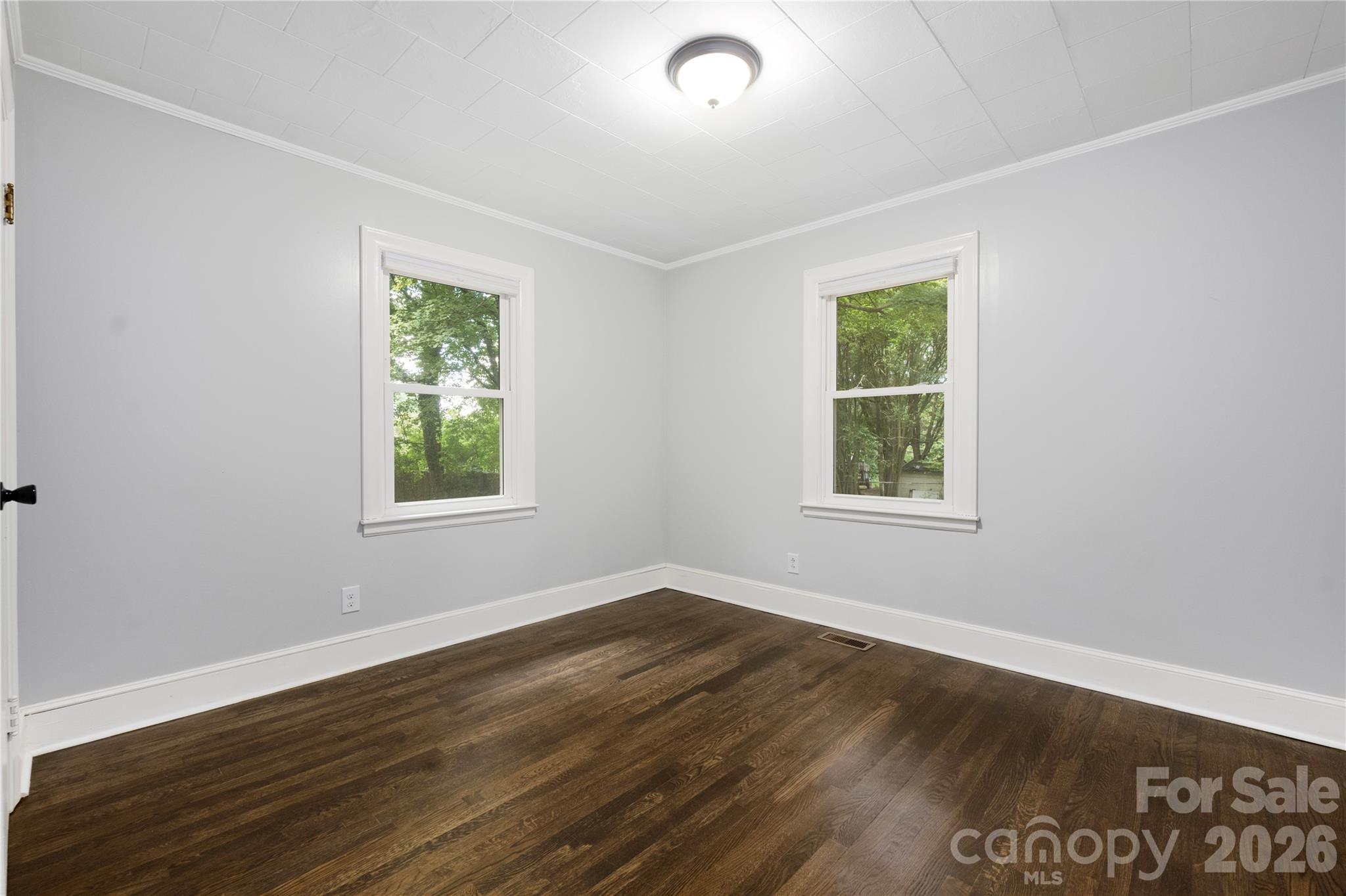 146 Staton Road Gastonia, NC 28056 - Photo 18 of 25 an empty room with wooden floor and windows