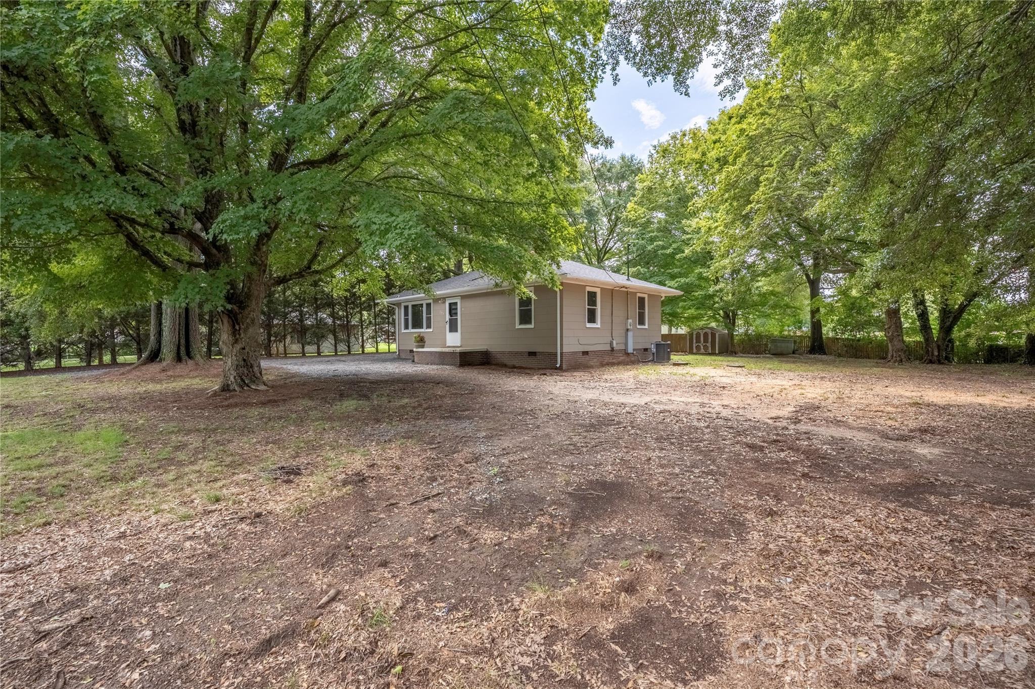 146 Staton Road Gastonia, NC 28056 - Photo 21 of 25 a view of a house with large trees and a small barn