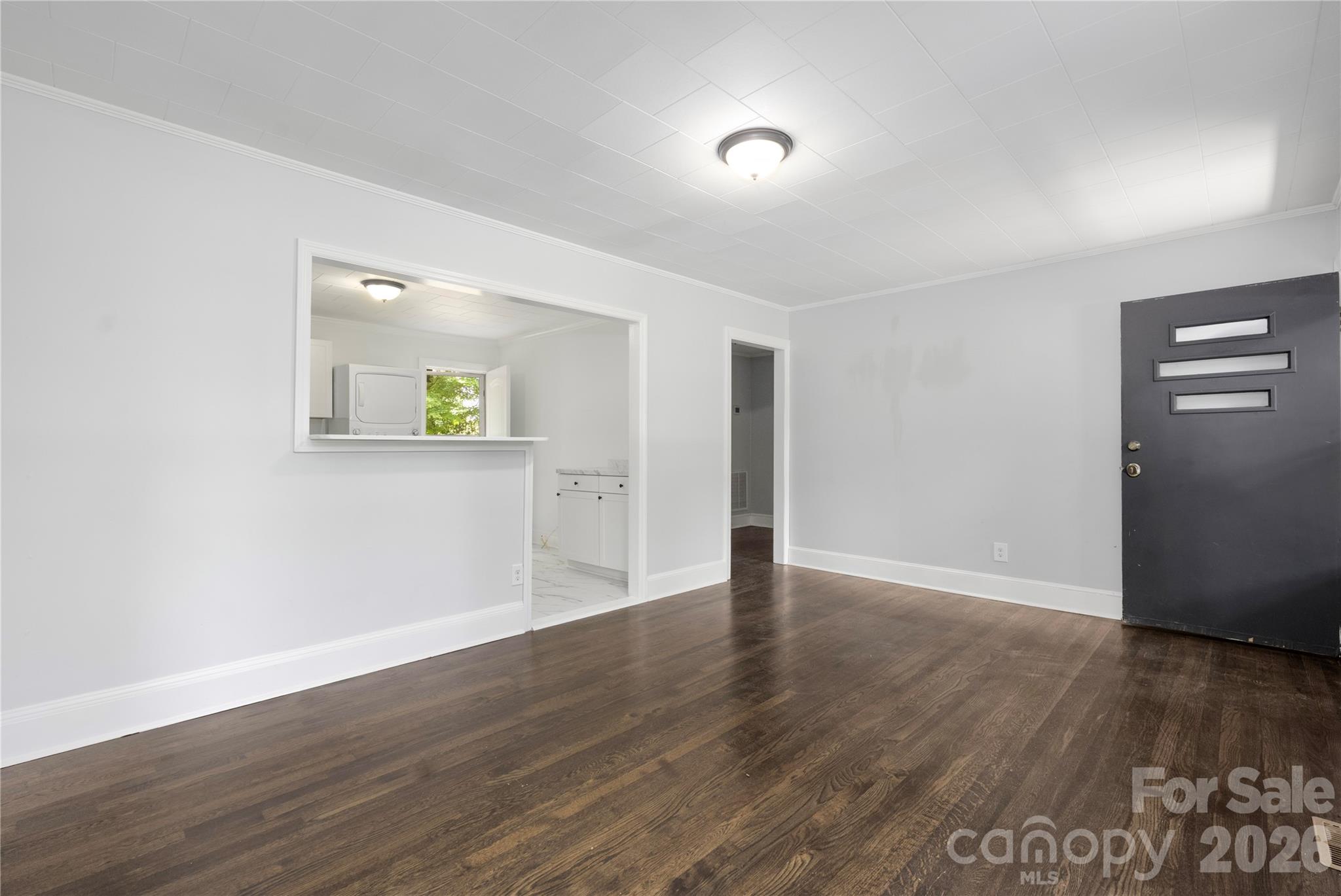 146 Staton Road Gastonia, NC 28056 - Photo 4 of 25 a view of an empty room with wooden floor and a window