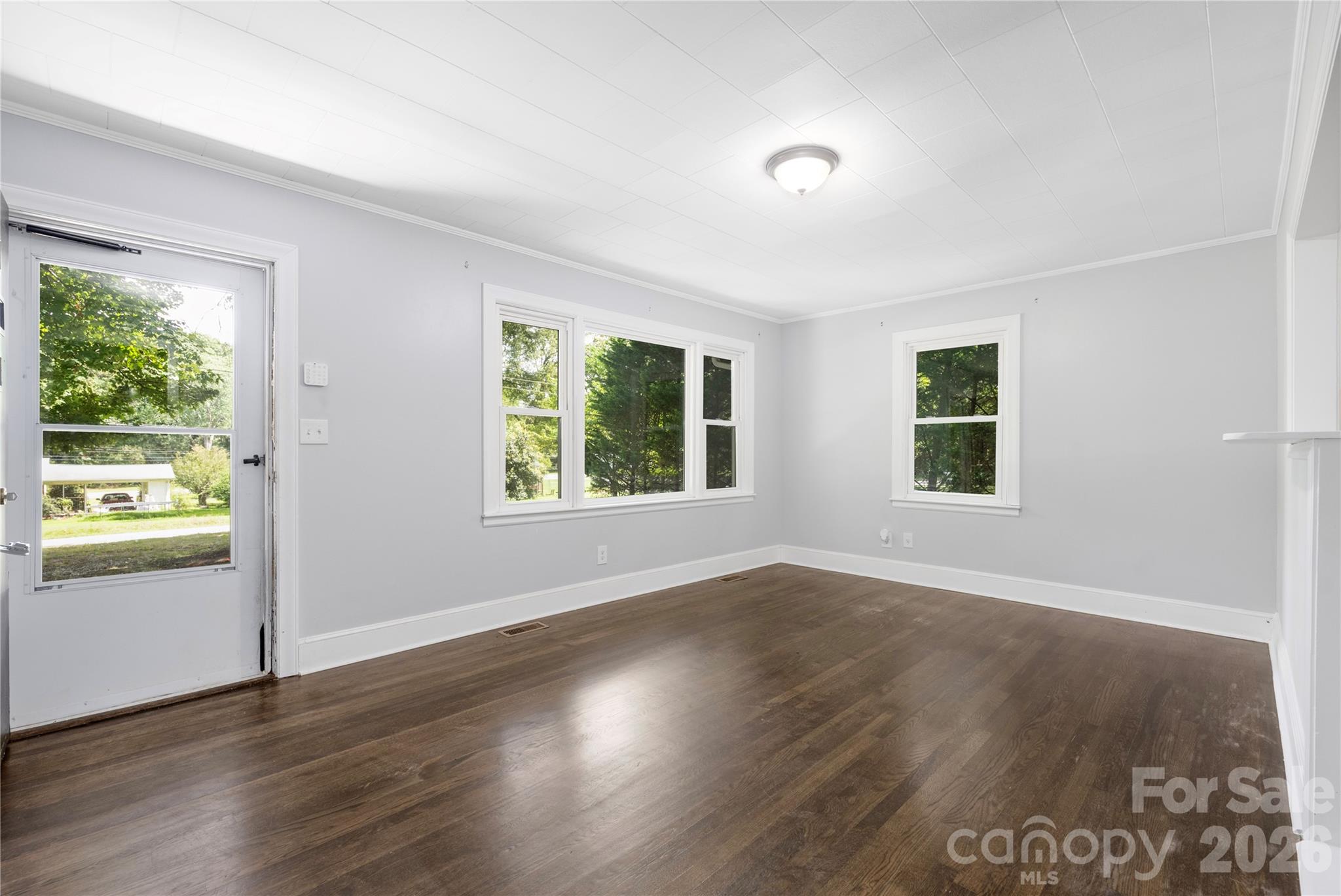 146 Staton Road Gastonia, NC 28056 - Photo 5 of 25 an empty room with wooden floor and windows