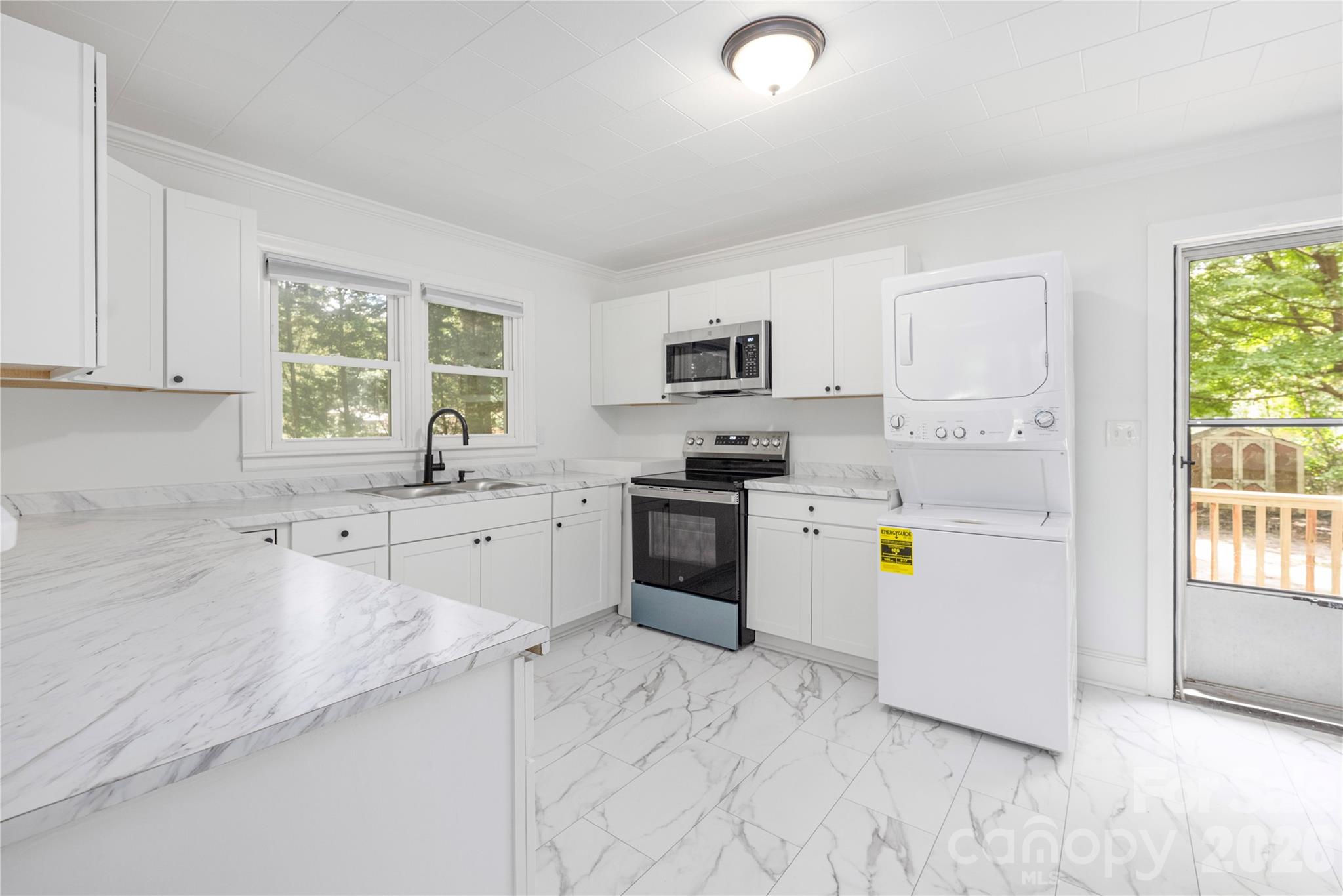 146 Staton Road Gastonia, NC 28056 - Photo 9 of 25 a kitchen with a sink a counter top space appliances and cabinets