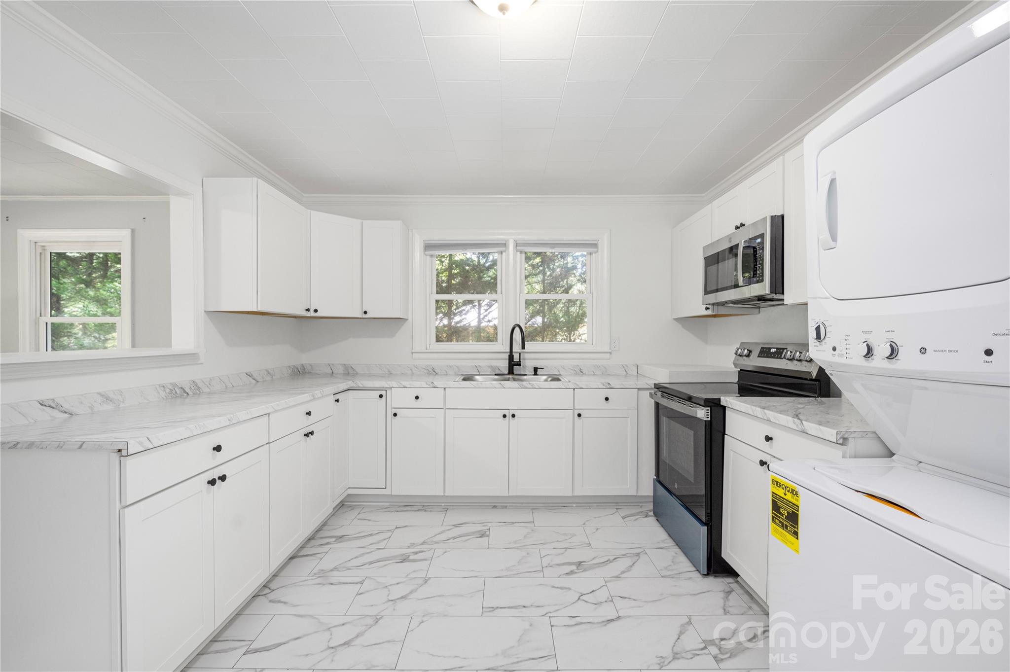 146 Staton Road Gastonia, NC 28056 - Photo 10 of 25 a kitchen that has a sink and a stove in it