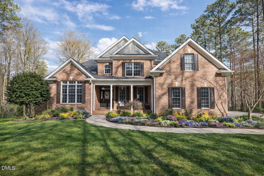 a front view of house with yard outdoor and green space