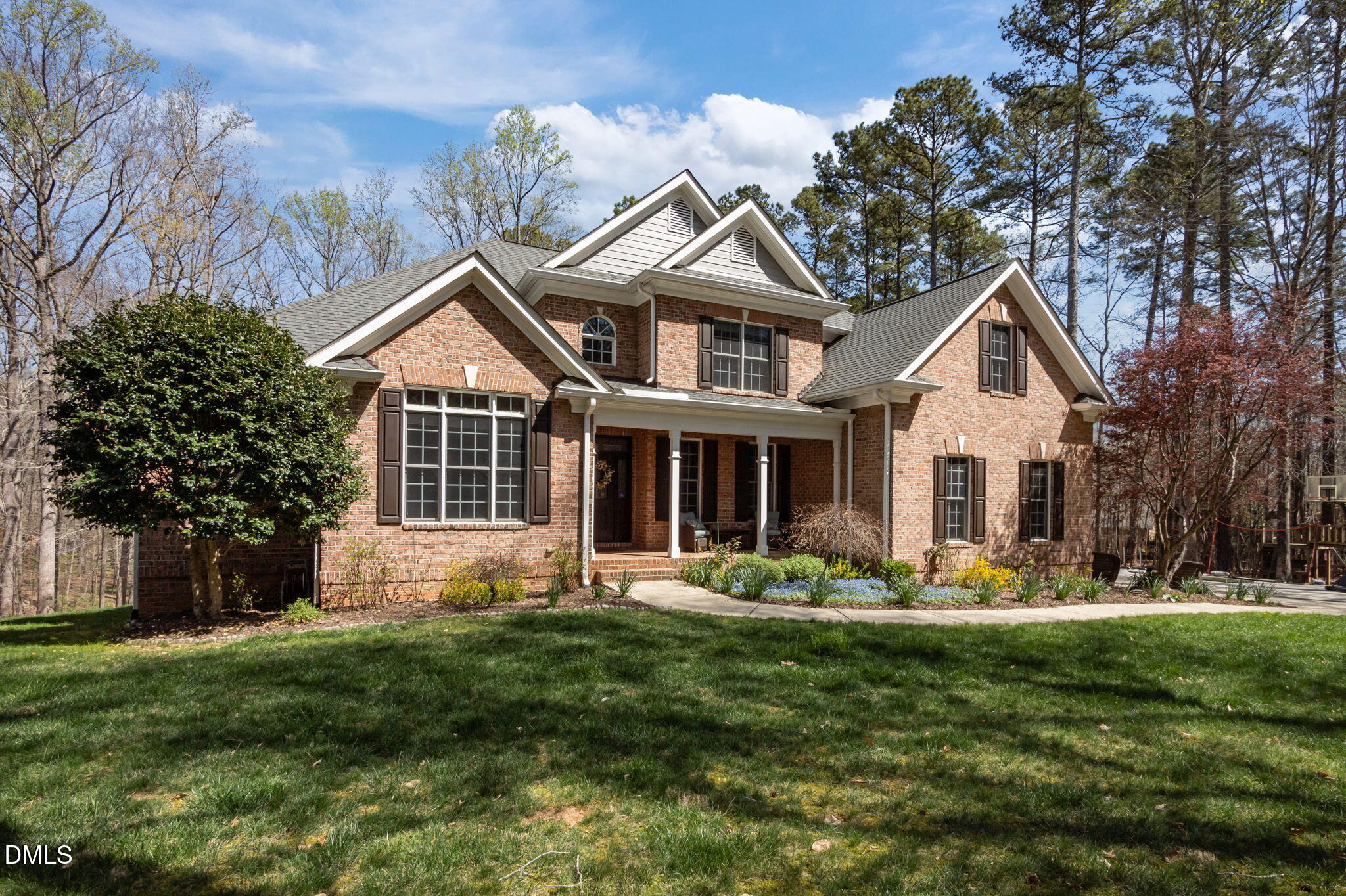 825 Oxbow Crossing Road Chapel Hill, NC 27516 - Photo 82 of 86 a front view of a house with a garden and trees