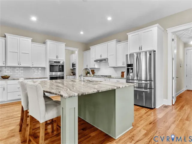 a kitchen with a table and chairs in it