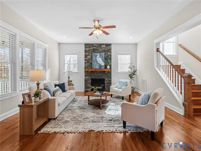a living room with furniture and wooden floor