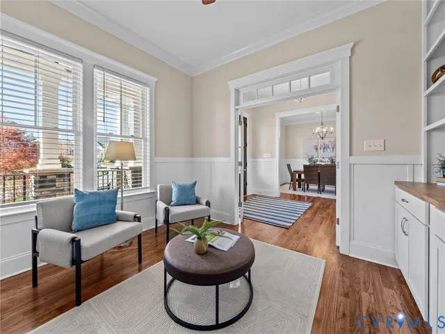 a view of a dining room with furniture a chandelier and wooden floor