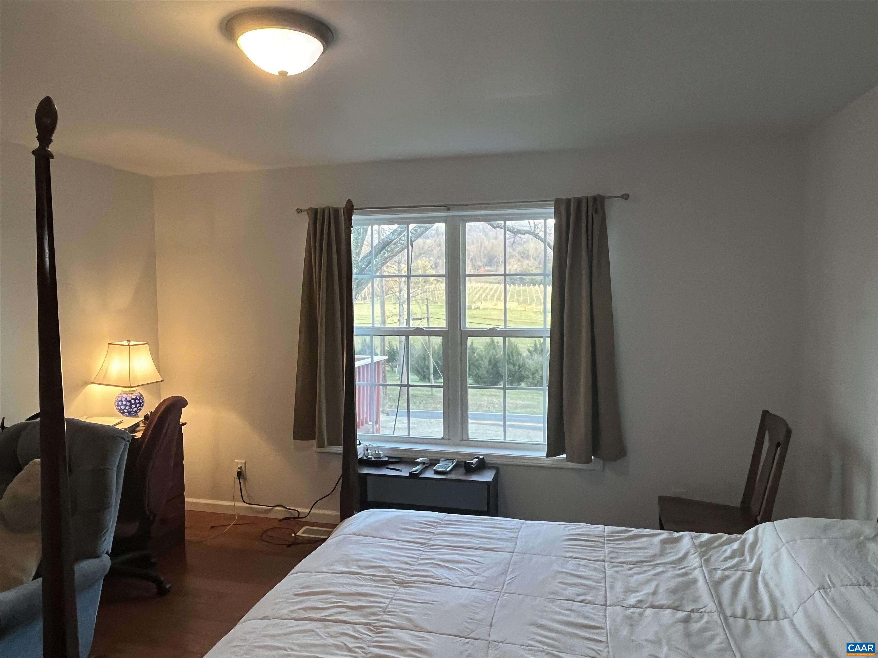 2150 Stony Point Road Charlottesville, VA 22911 - Photo 13 of 40 a bedroom with a large bed and two windows