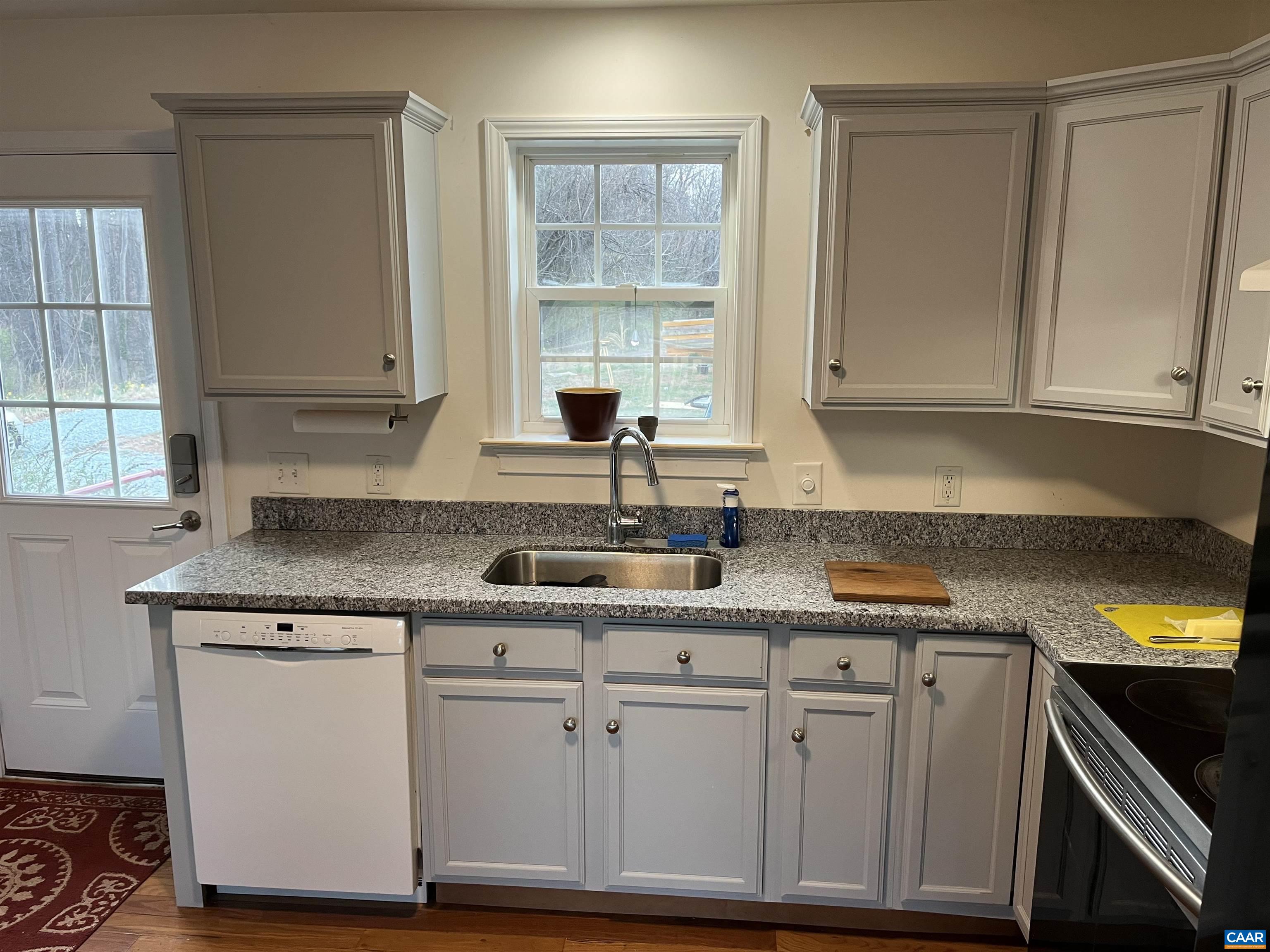 2150 Stony Point Road Charlottesville, VA 22911 - Photo 27 of 40 a kitchen with granite countertop a sink a stove and cabinets