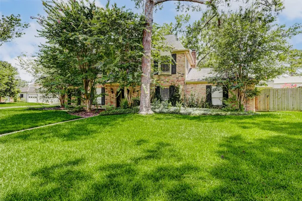 a view of house with backyard