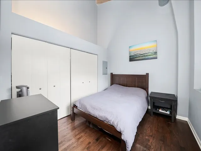 a bedroom with a bed and a desk