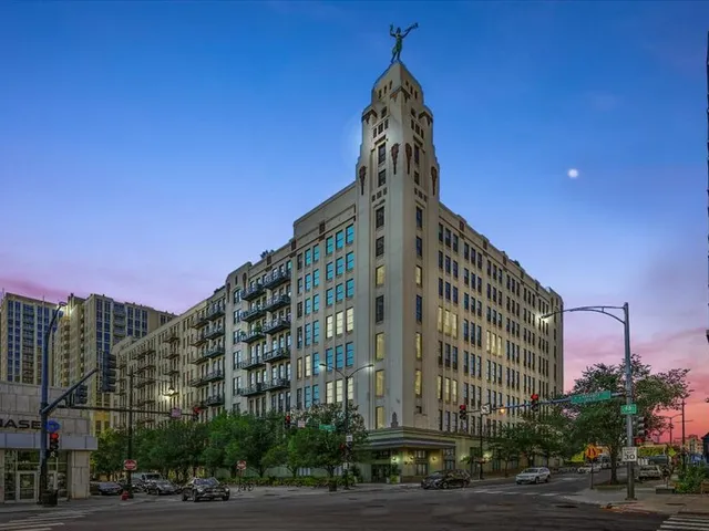 a view of a tall building next to a street